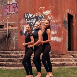 three dancers in black leotards and leggings